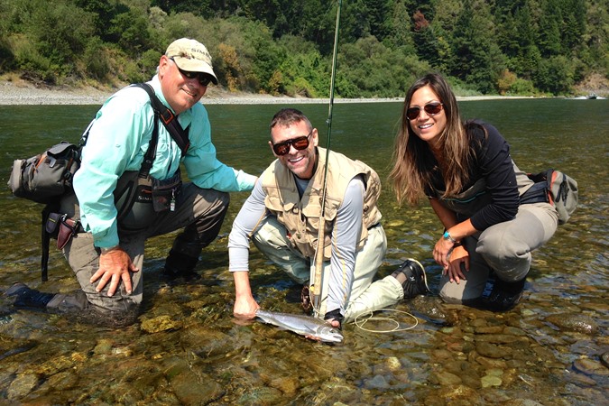 Gino, Leslie, and a happy guest with a steelhead