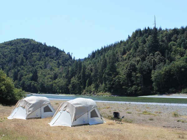 Guest tents with the river in the background